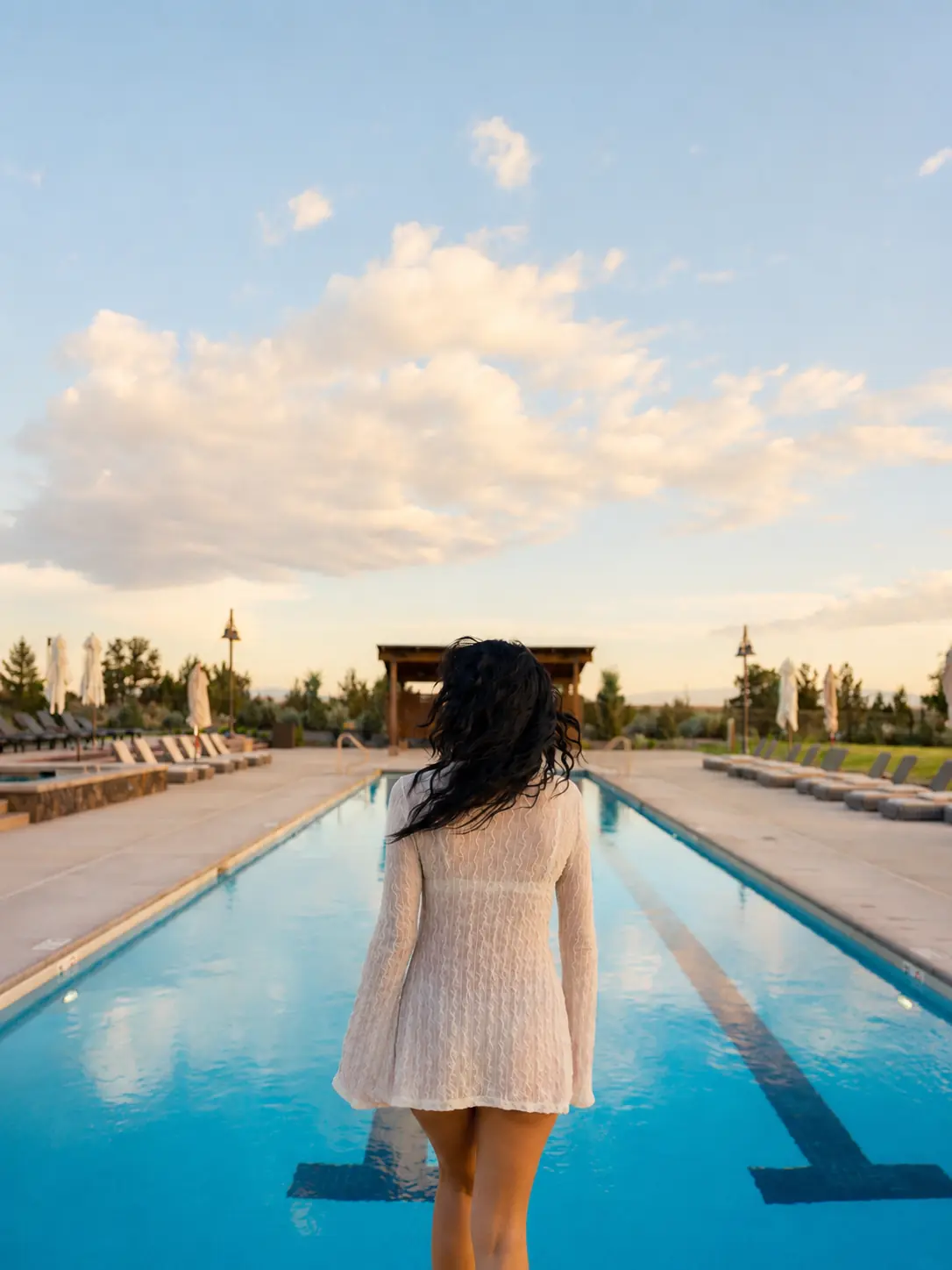 Guest walking beside the long pool at Brasada Ranch