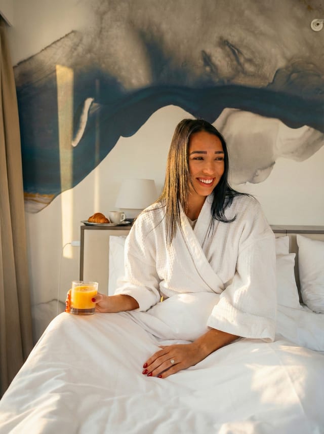 Guest relaxing on the bed at Delta Downtown
