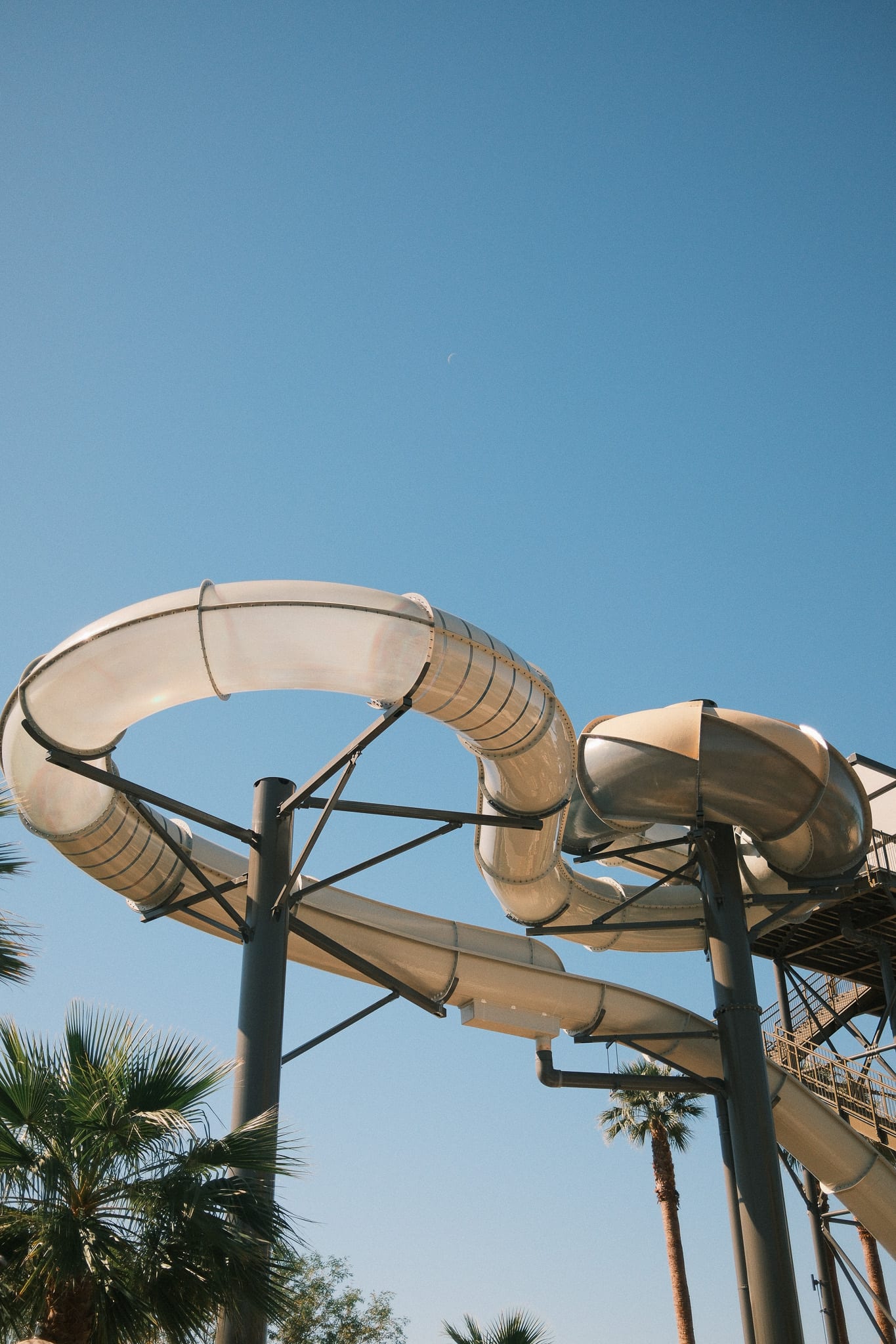 Resort waterslides against a clear blue sky at Desert Ridge