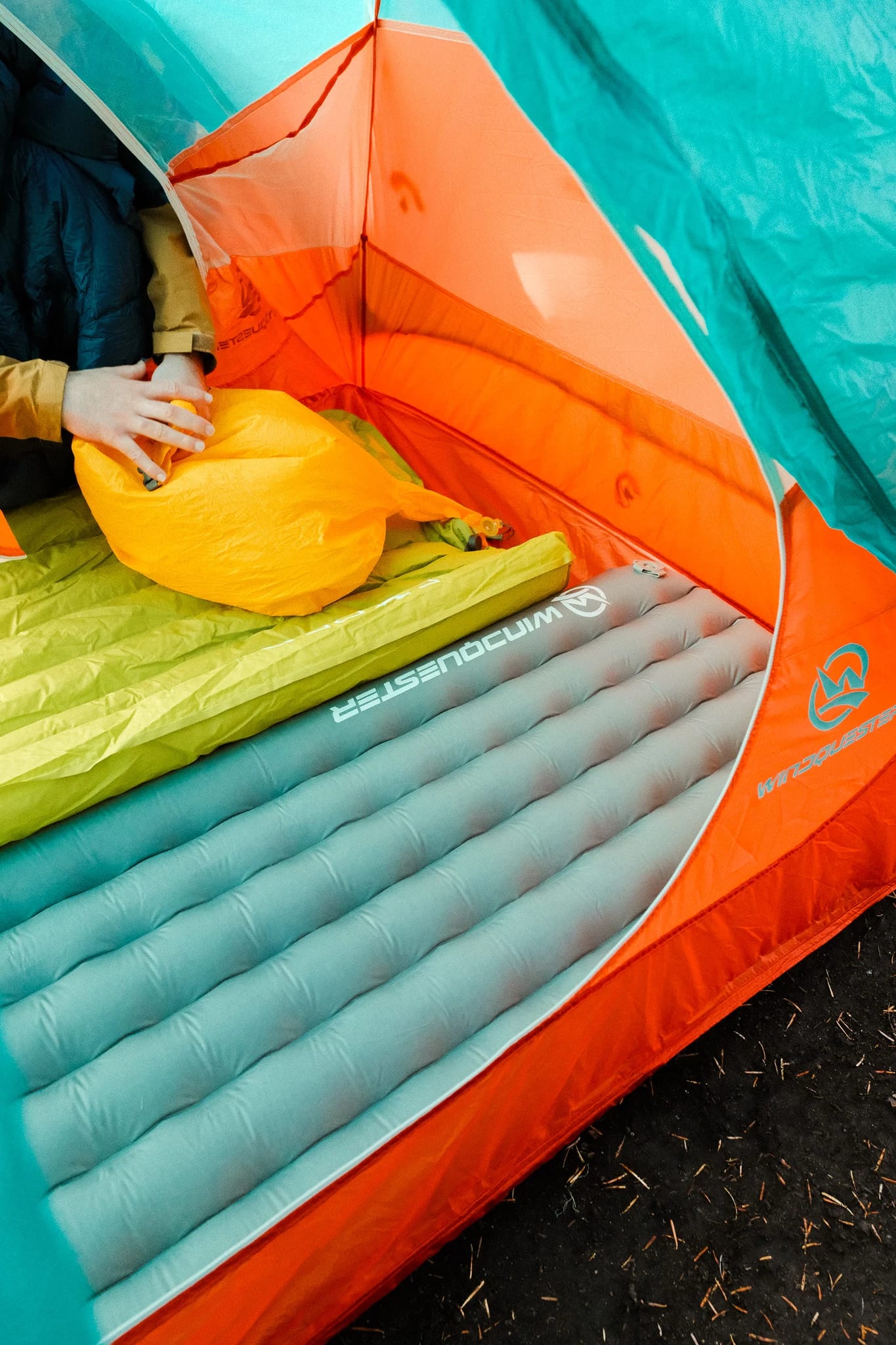 WindQuester sleeping pad inside a turquoise and orange tent