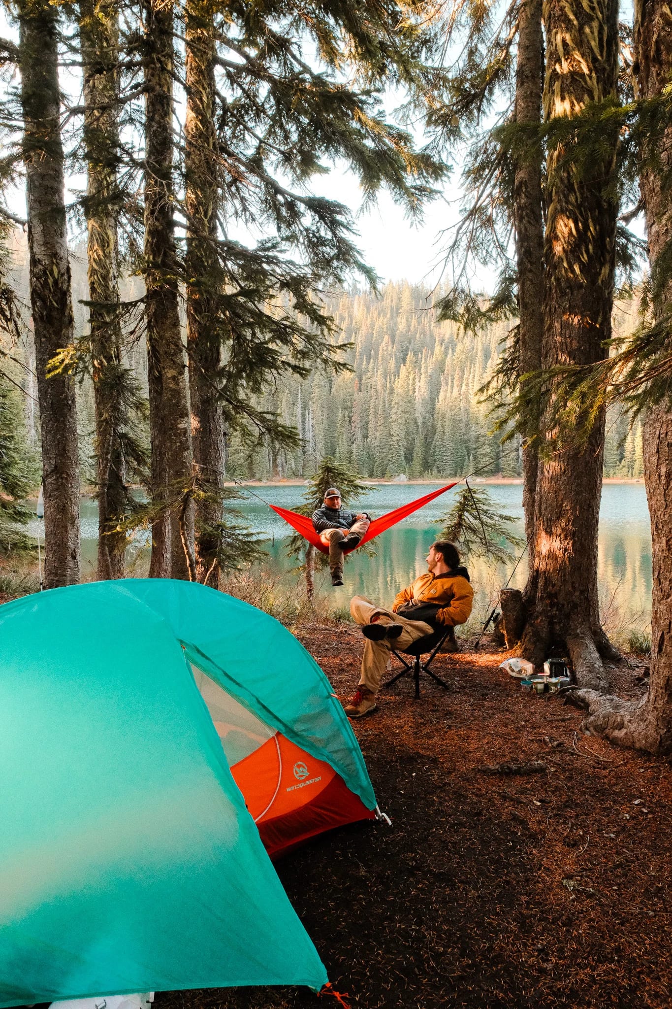 WindQuester tent, CLIQ chair and Kammok hammock at a wooded lakeside campsite
