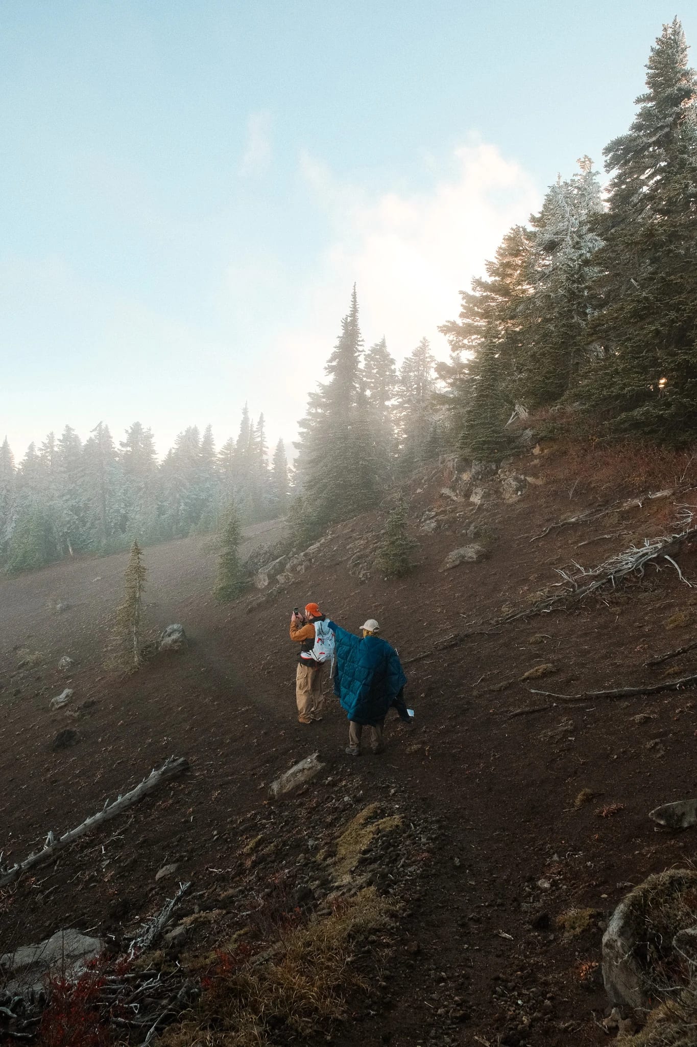 Hikers following a rocky trail through the mountain landscape