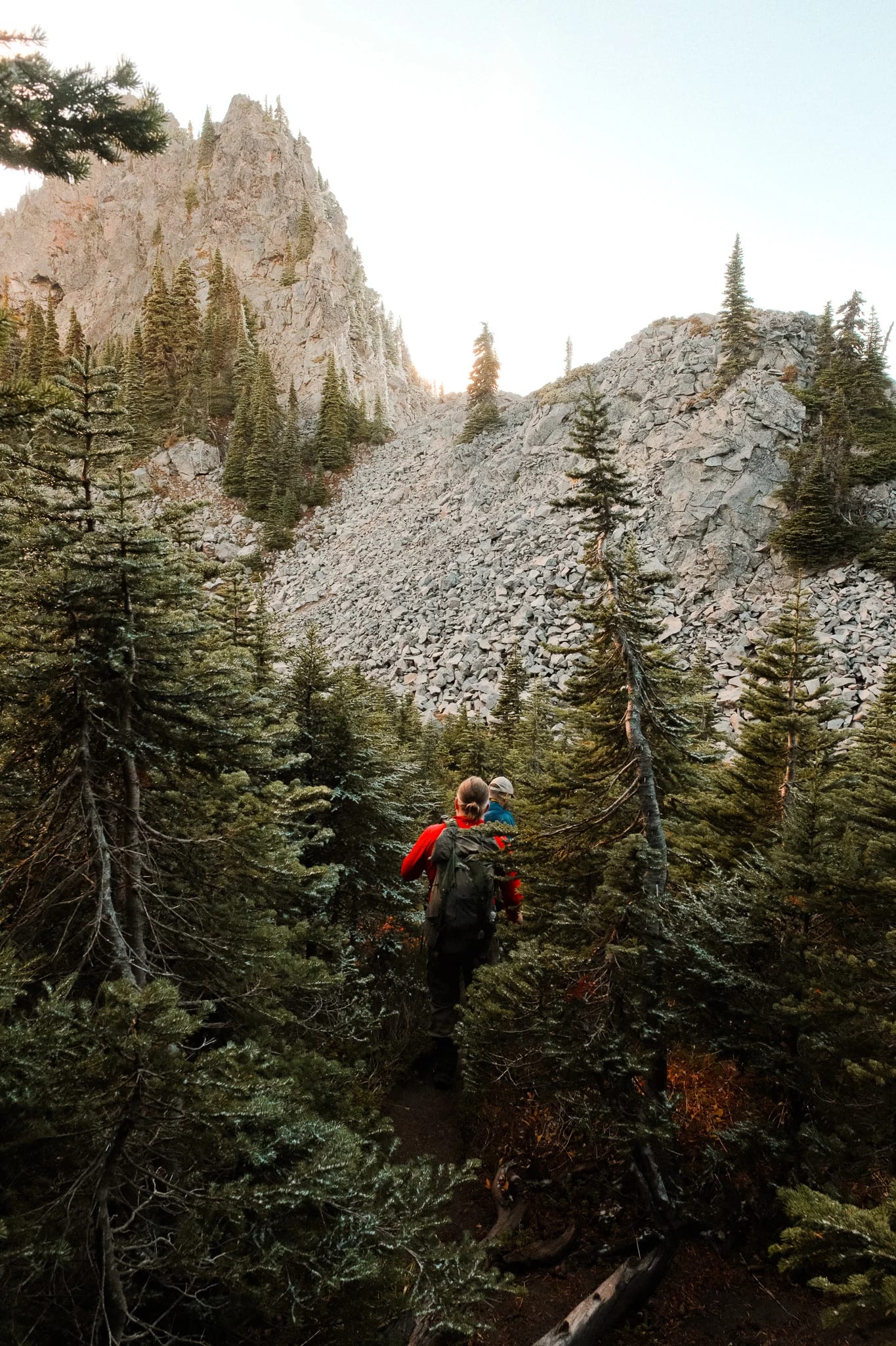 Hikers following a rocky trail through the mountain landscape