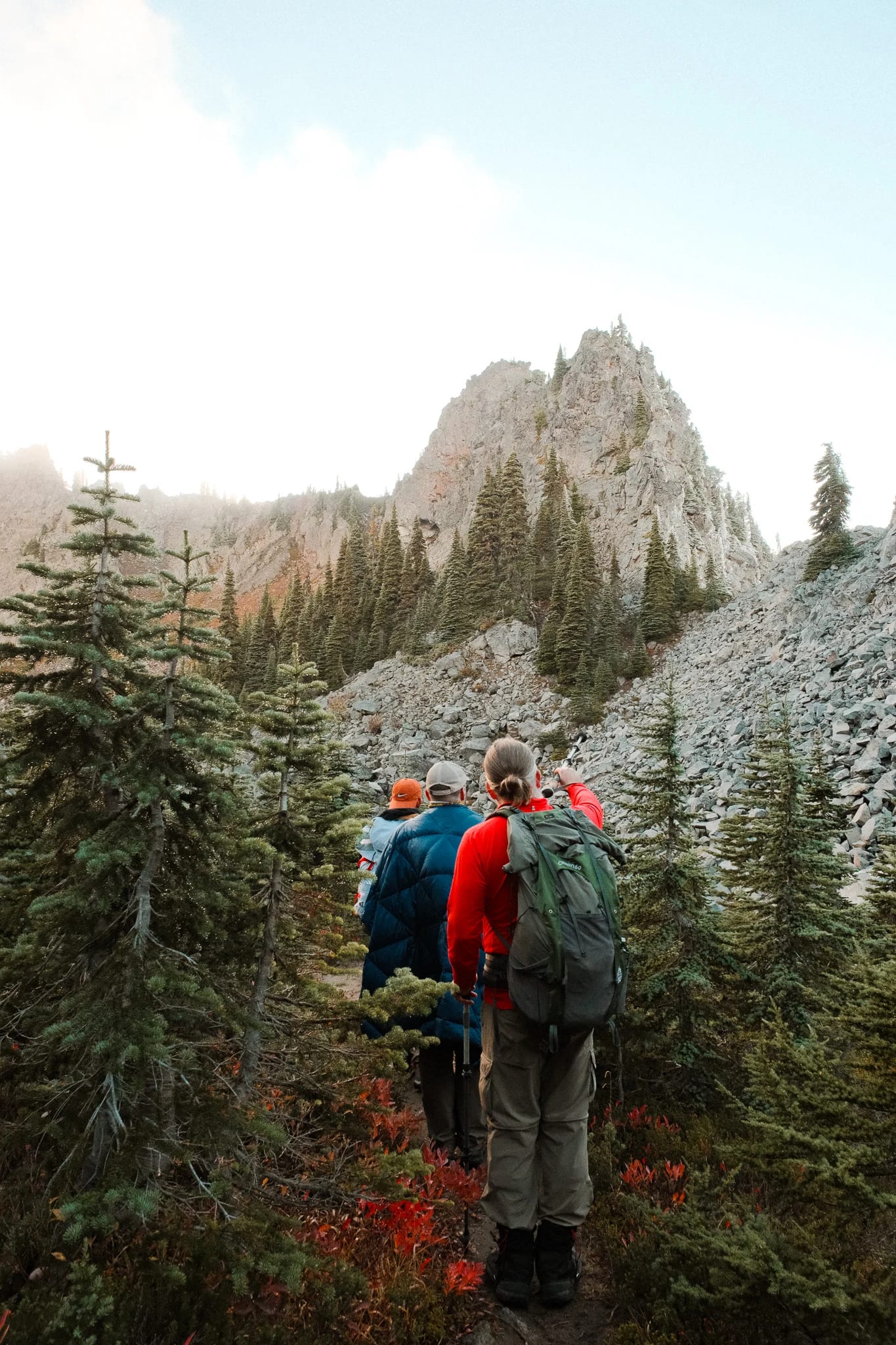 Hikers following a rocky trail through the mountain landscape