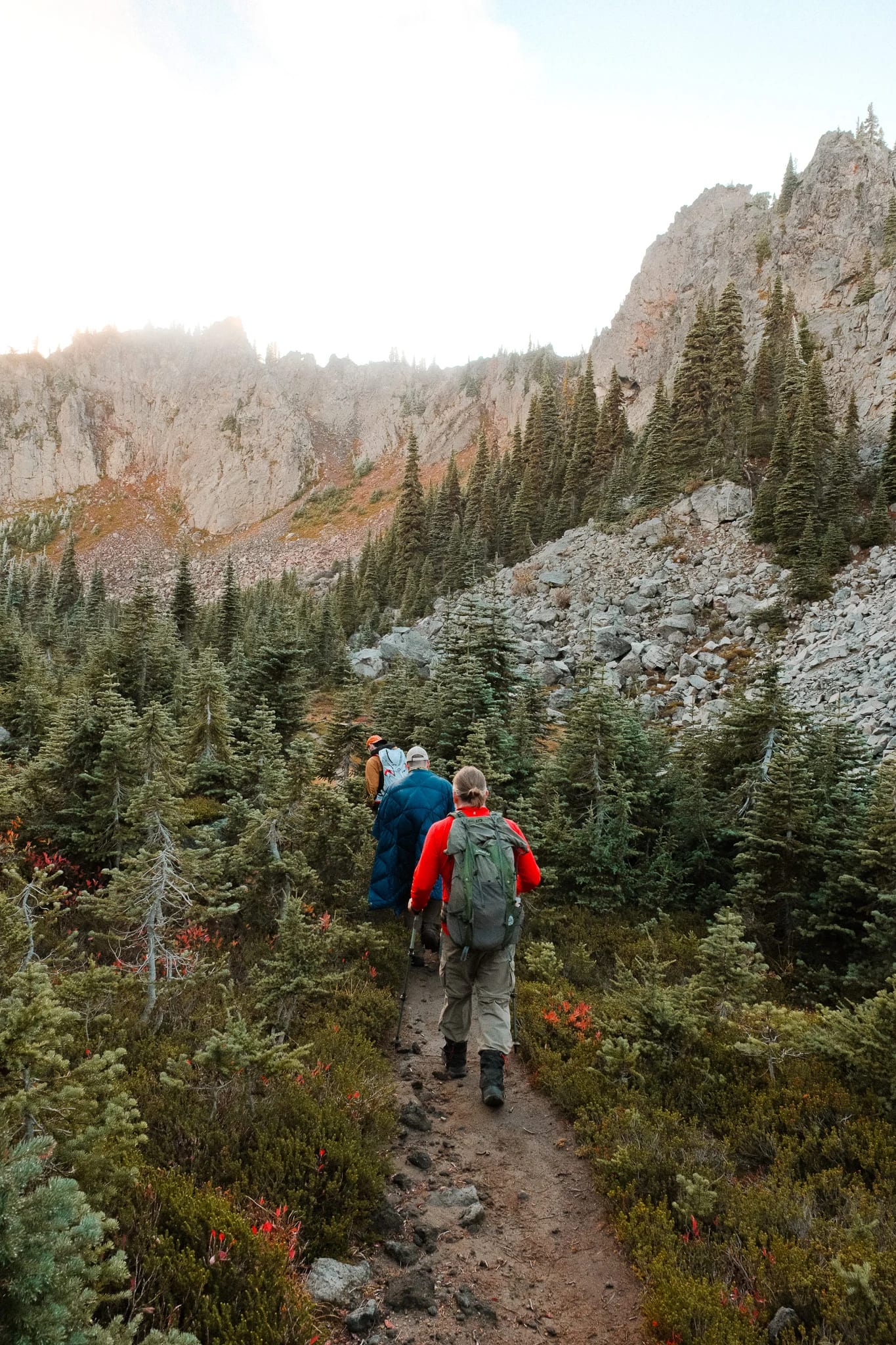 Hikers following a rocky trail through the mountain landscape
