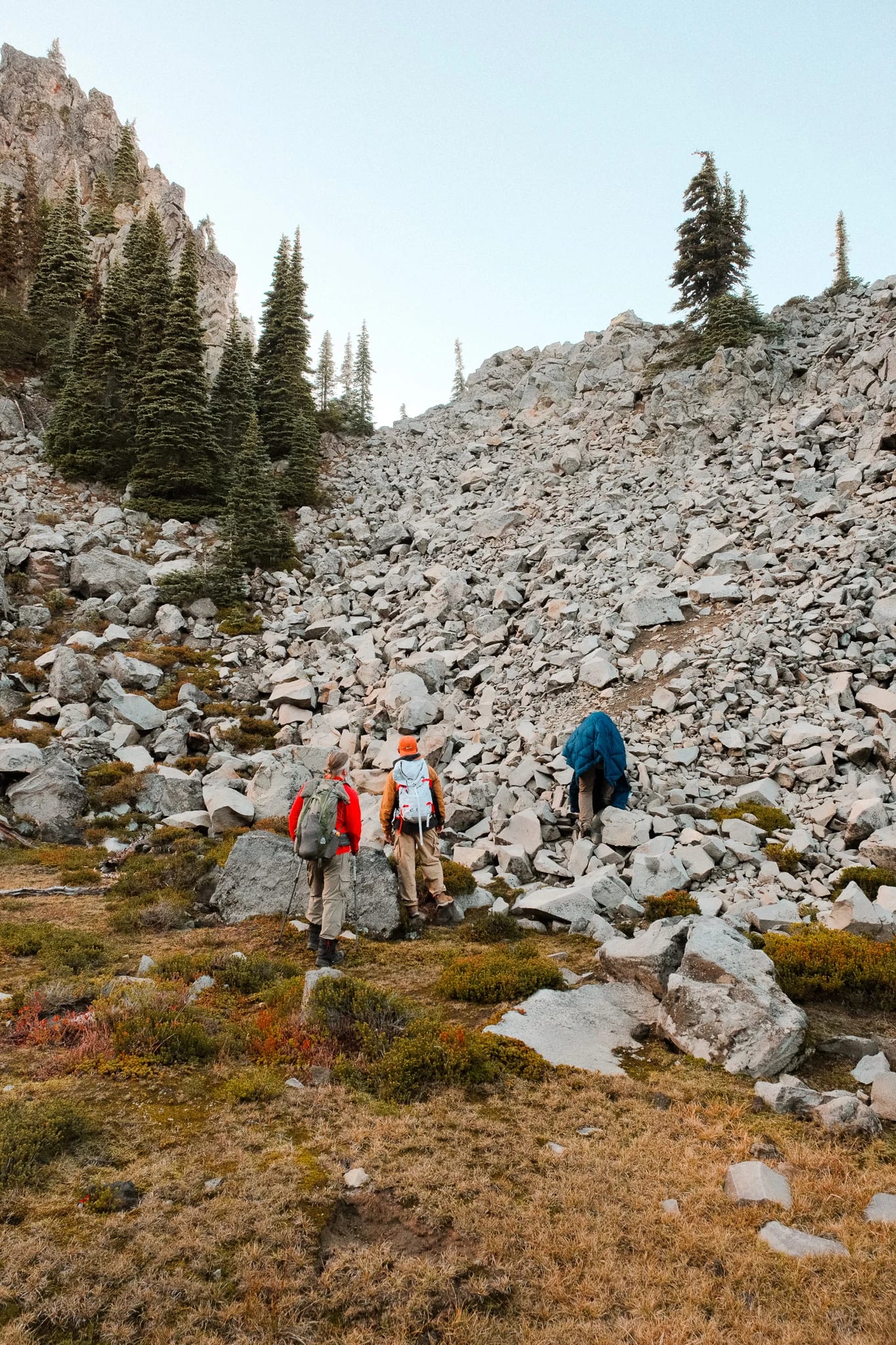Hikers following a rocky trail through the mountain landscape