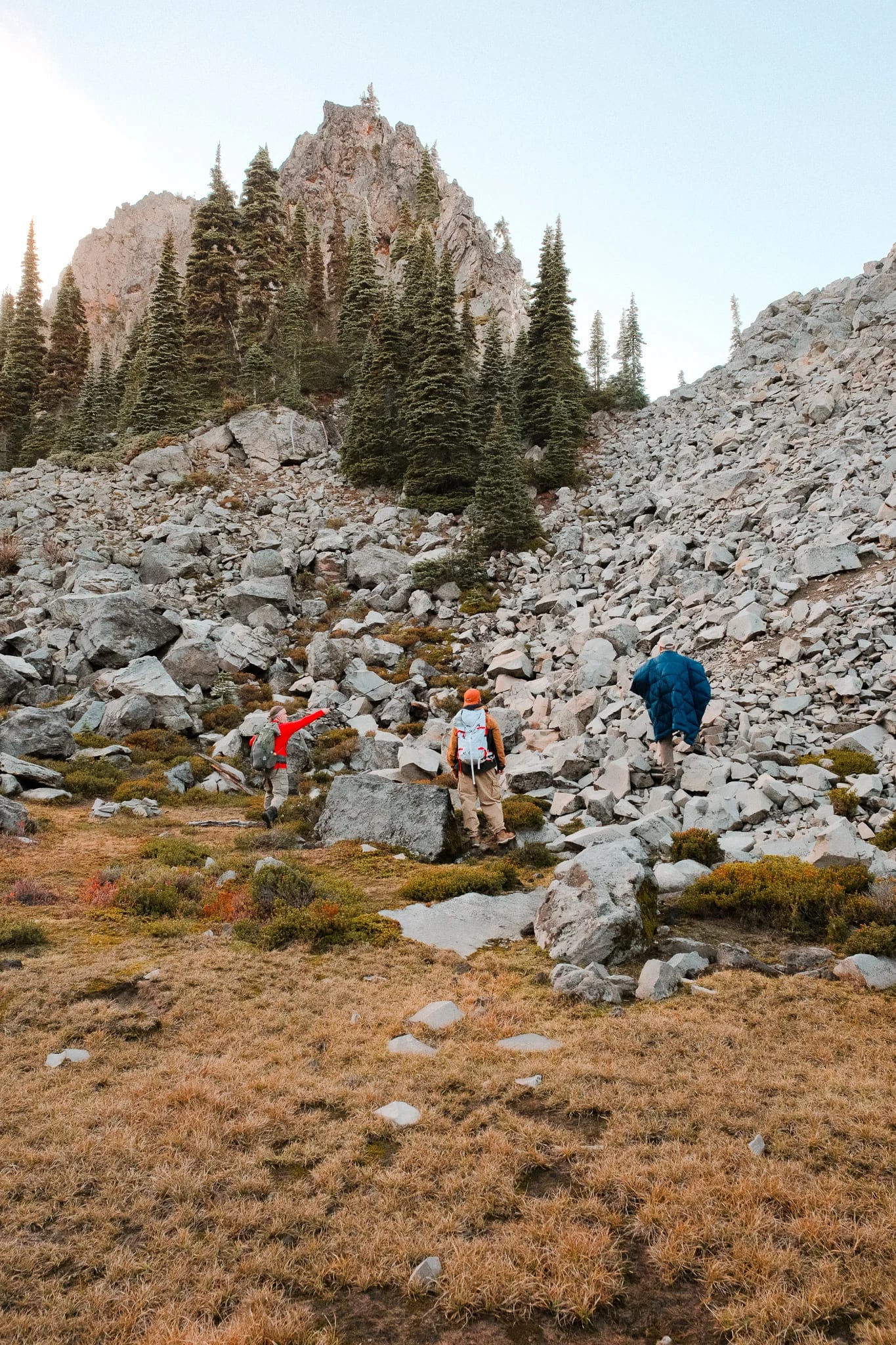 Hikers following a rocky trail through the mountain landscape