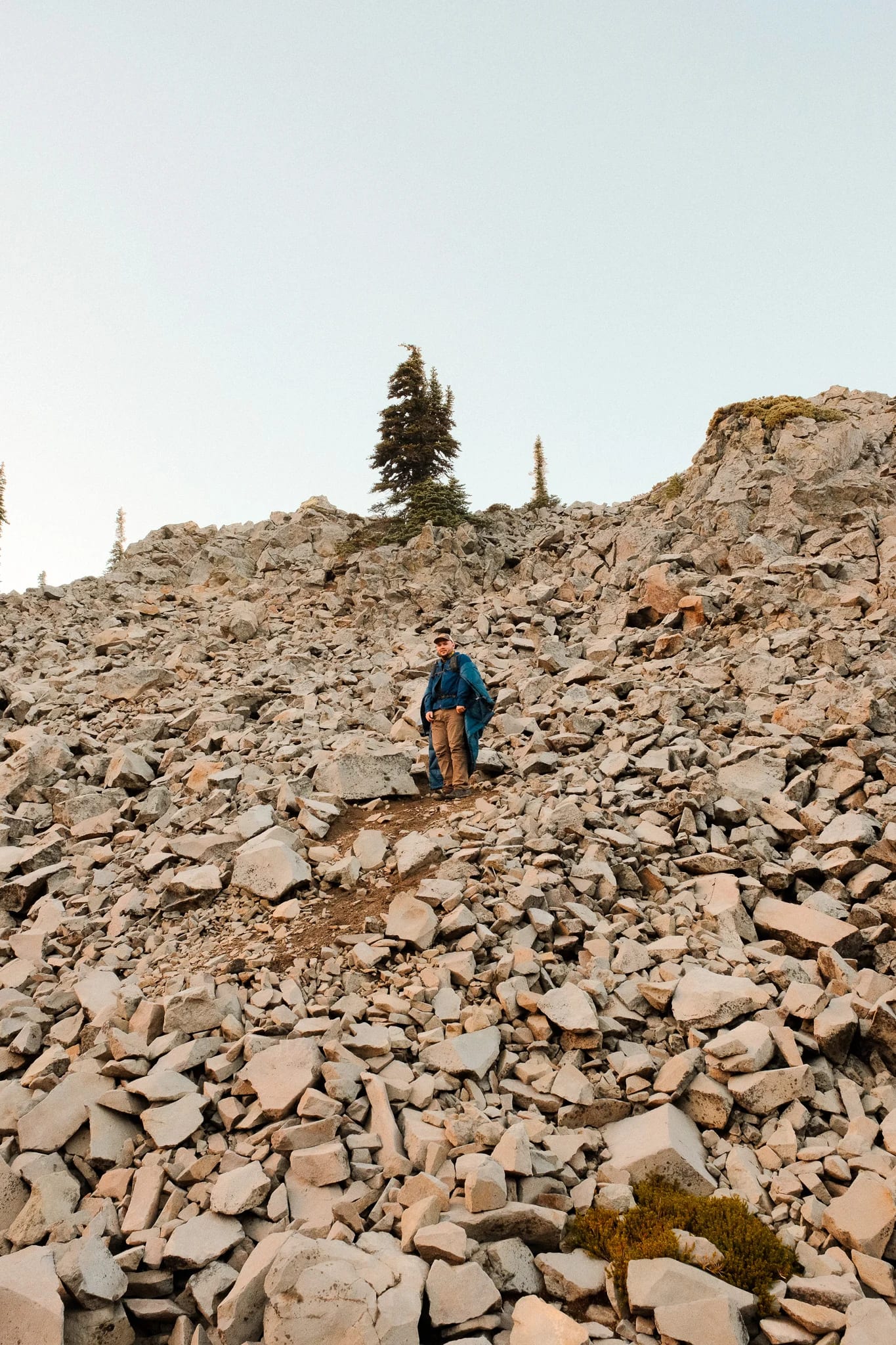 Hikers following a rocky trail through the mountain landscape