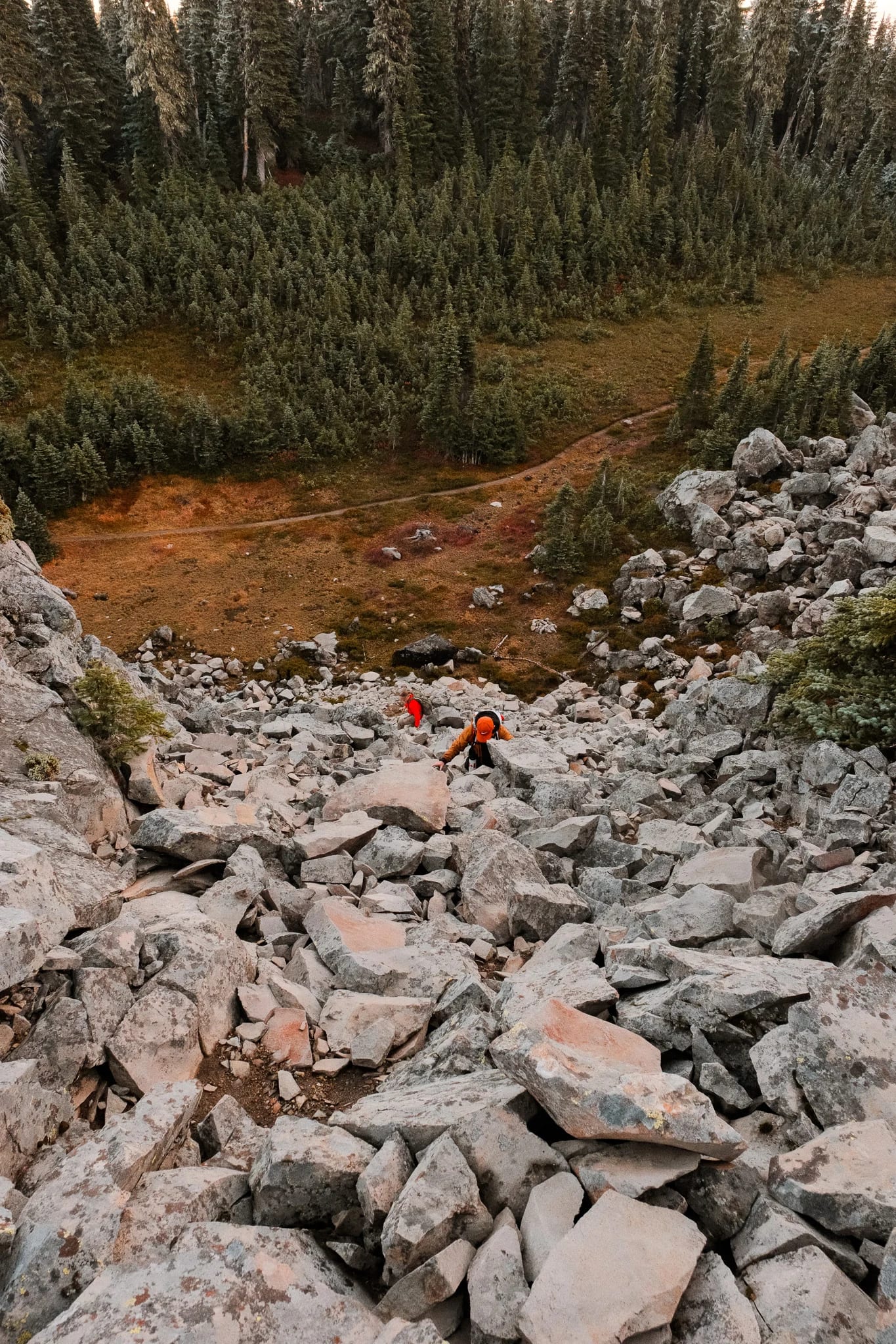 Hikers following a rocky trail through the mountain landscape