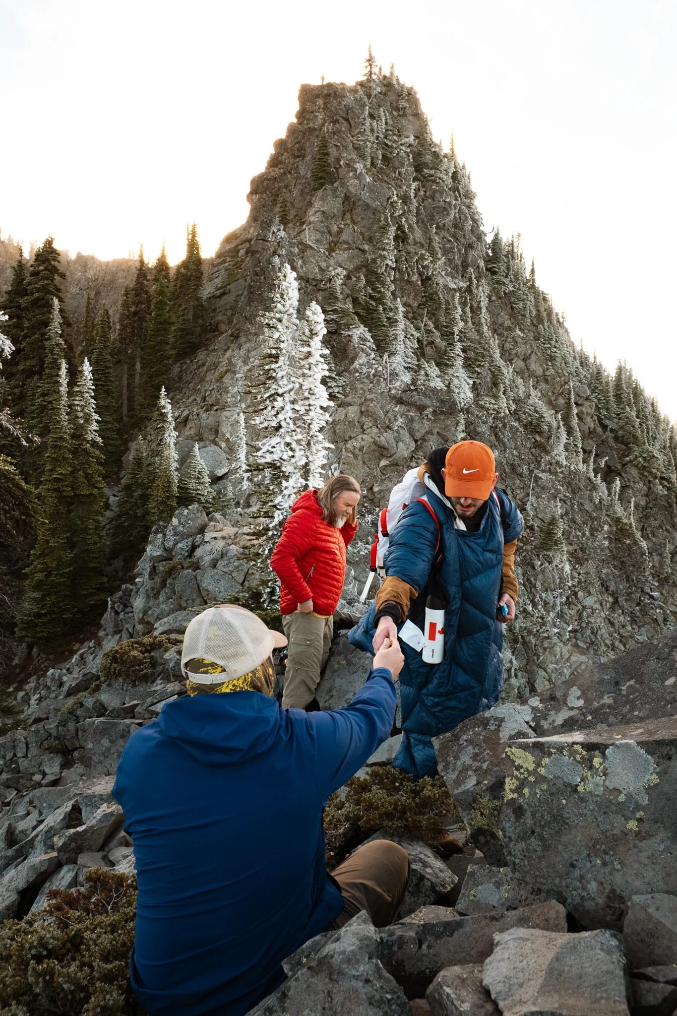 Hikers following a rocky trail through the mountain landscape