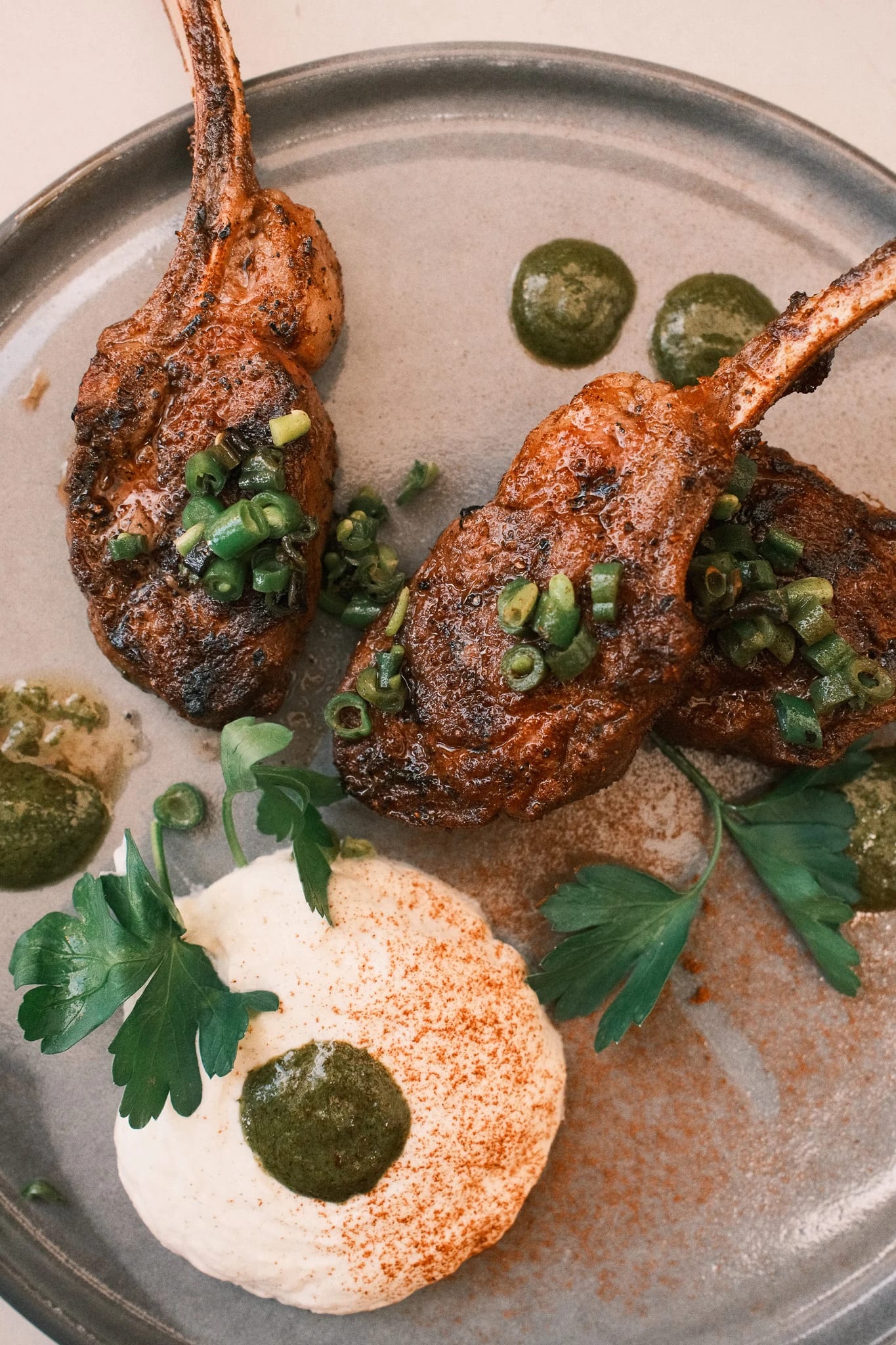 An overhead view of lamb chops and greens.