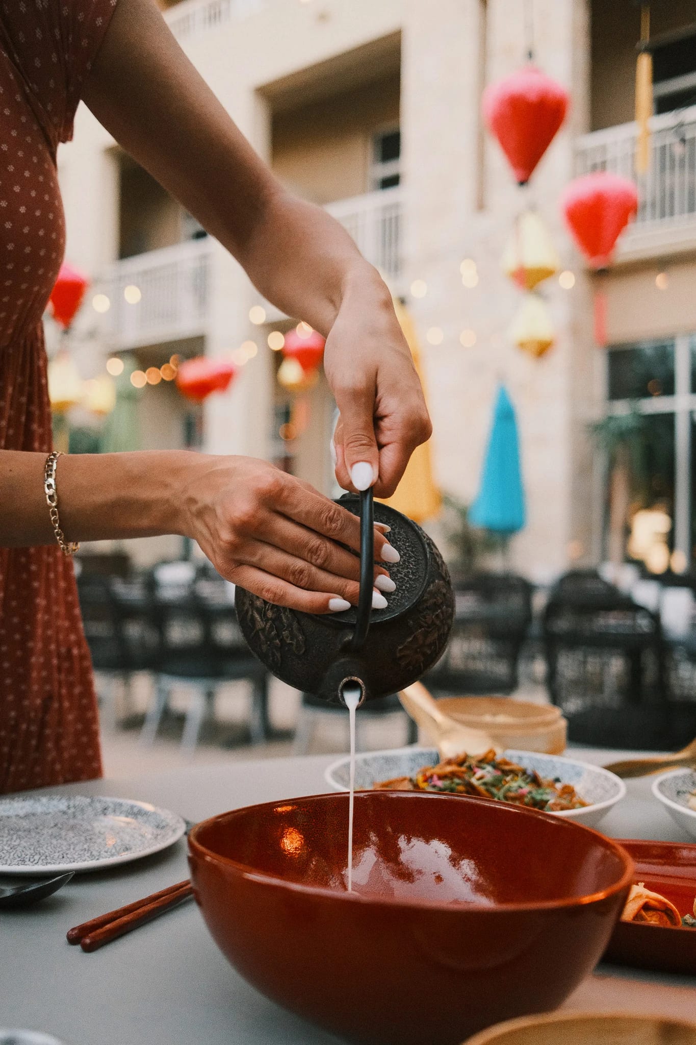 Sauce is poured over a restaurant dish.