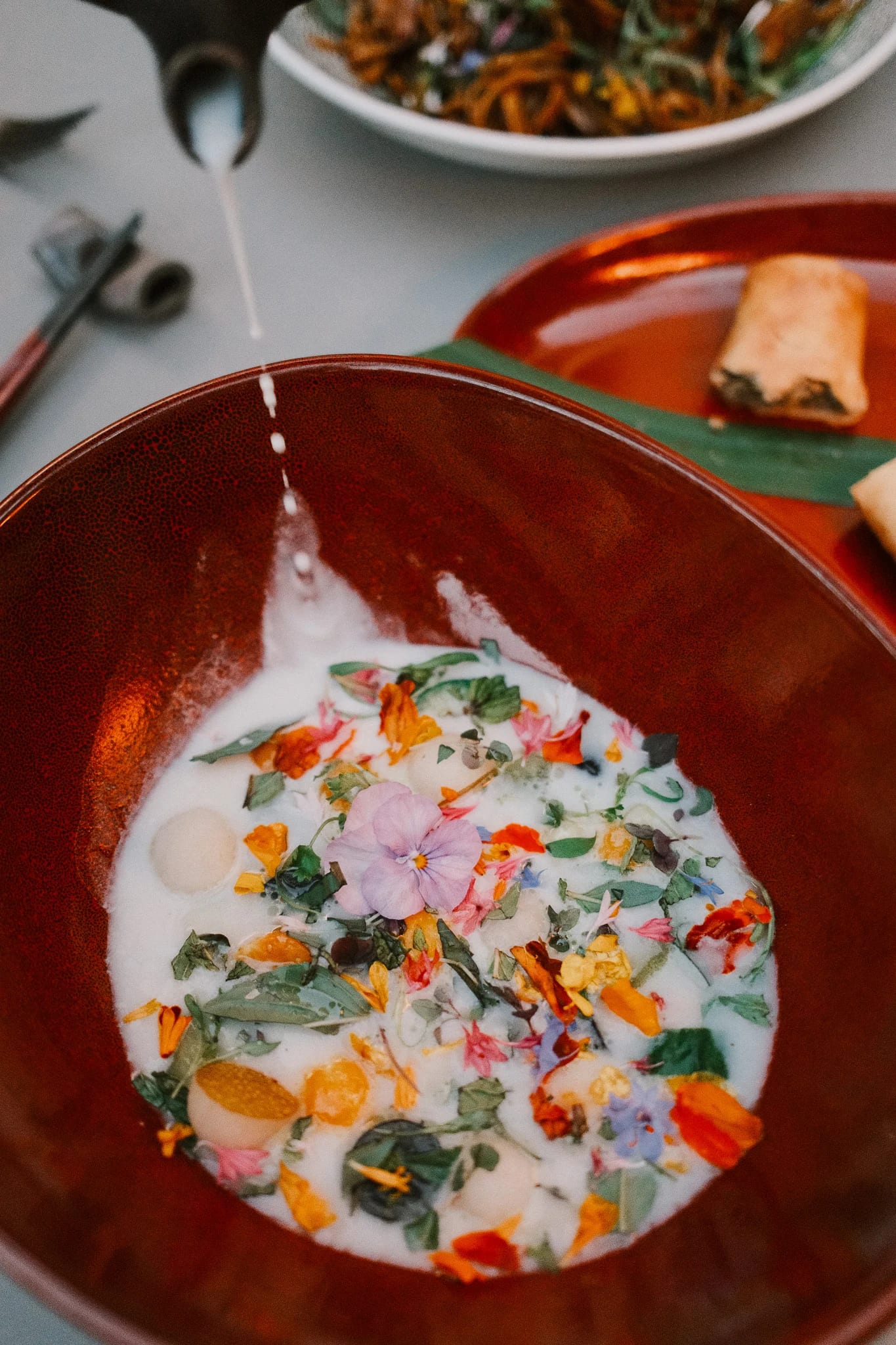 A colourful plated dish in a red bowl.