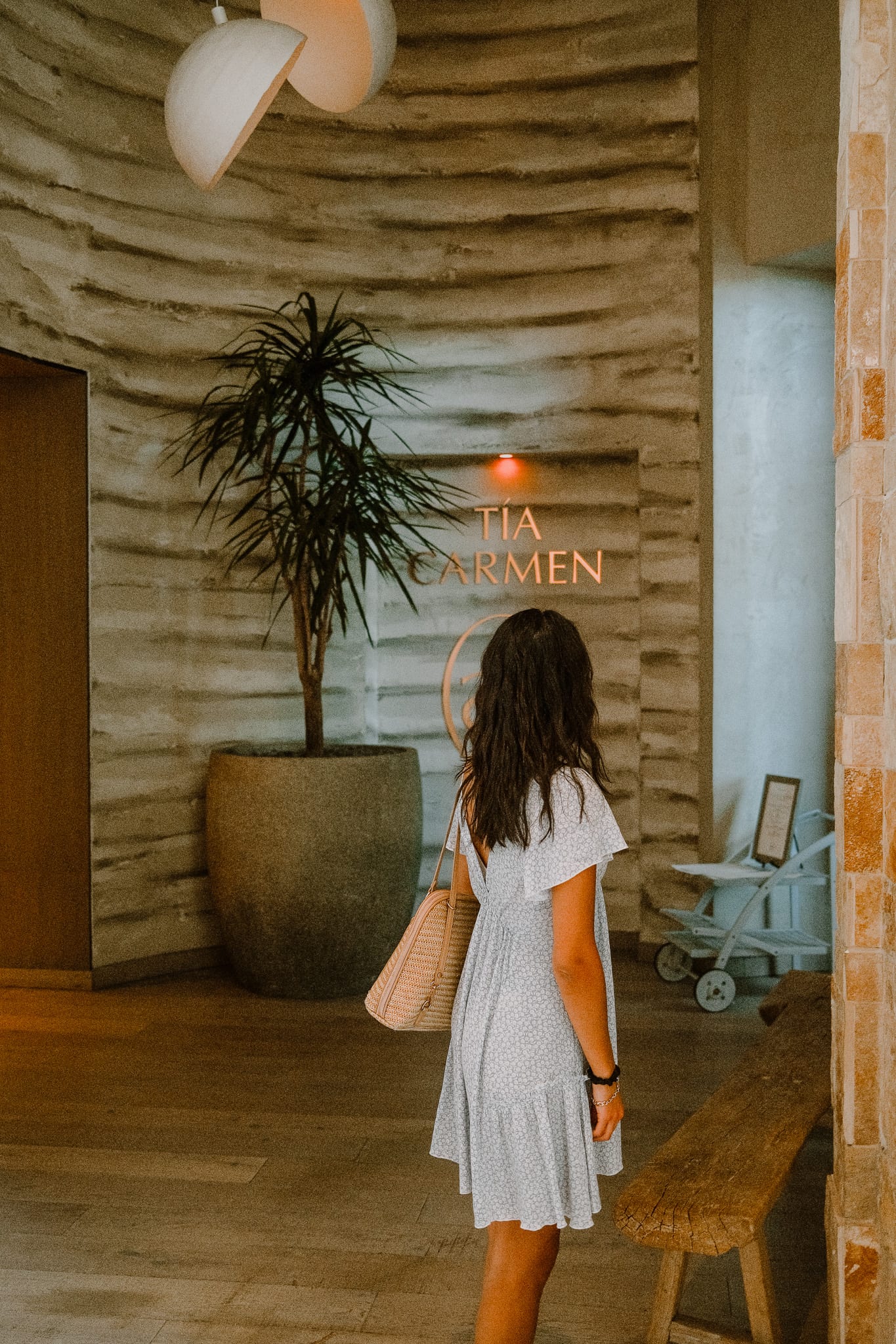 A guest in a white robe walks through a softly lit spa entrance at Desert Ridge.