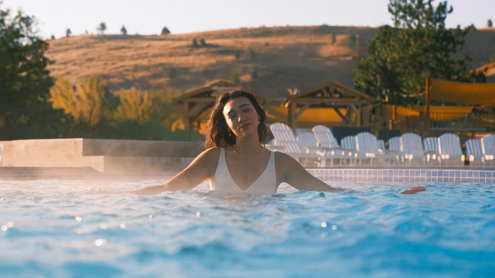 A guest leans back in warm water.