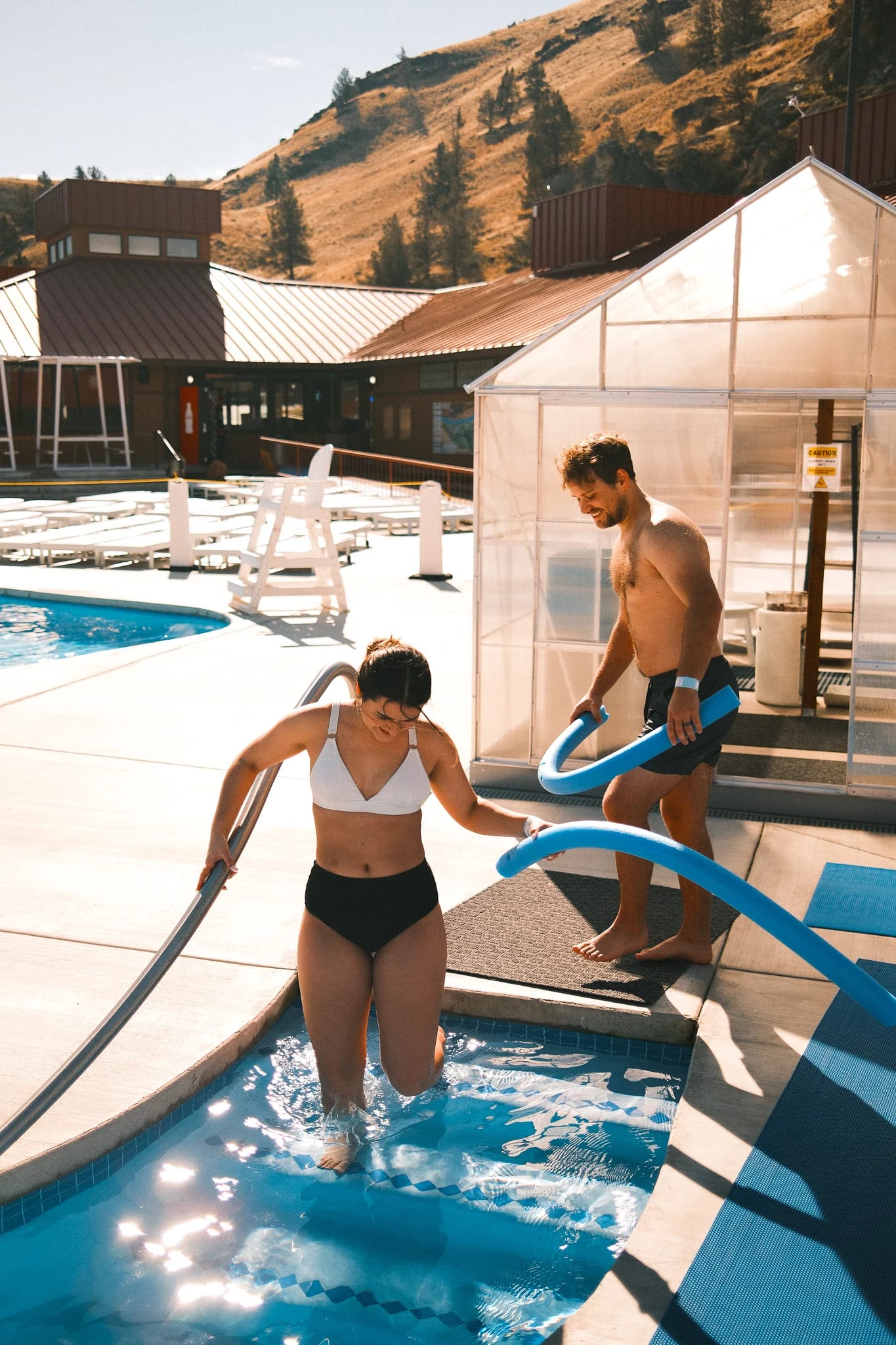 Children play beside the shallow pool.