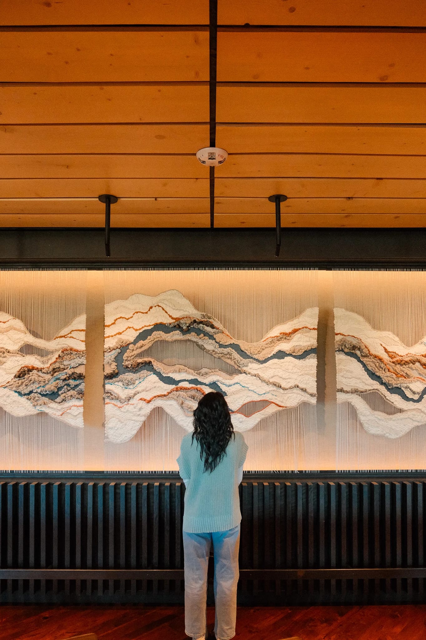 Guest looking at mountain artwork inside Suncadia