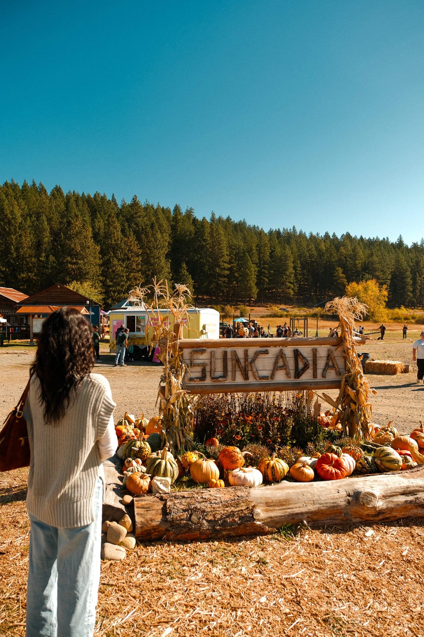Guest beside a Suncadia harvest festival display