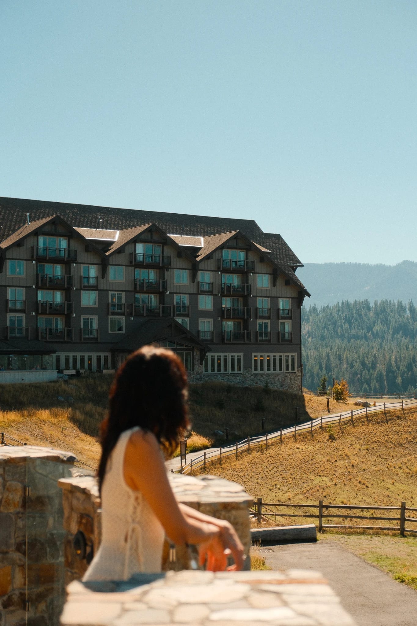 Guest relaxing on a terrace overlooking the Suncadia lodge