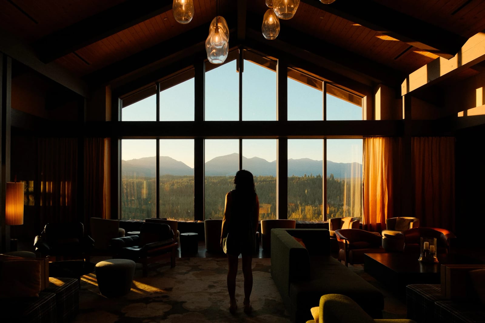 Silhouetted guest in the Suncadia lounge at sunset