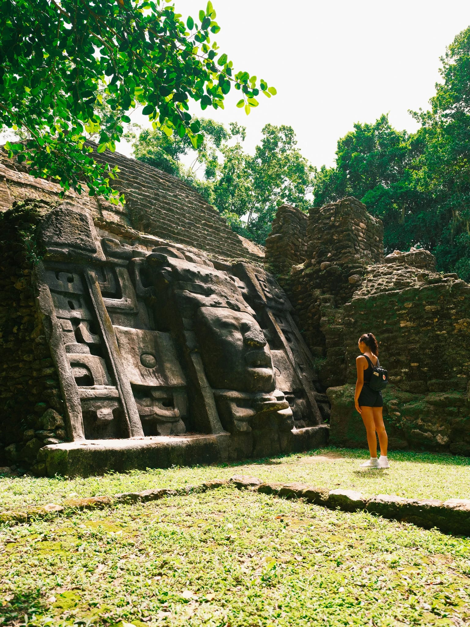 A traveller stands beside ancient stone steps.