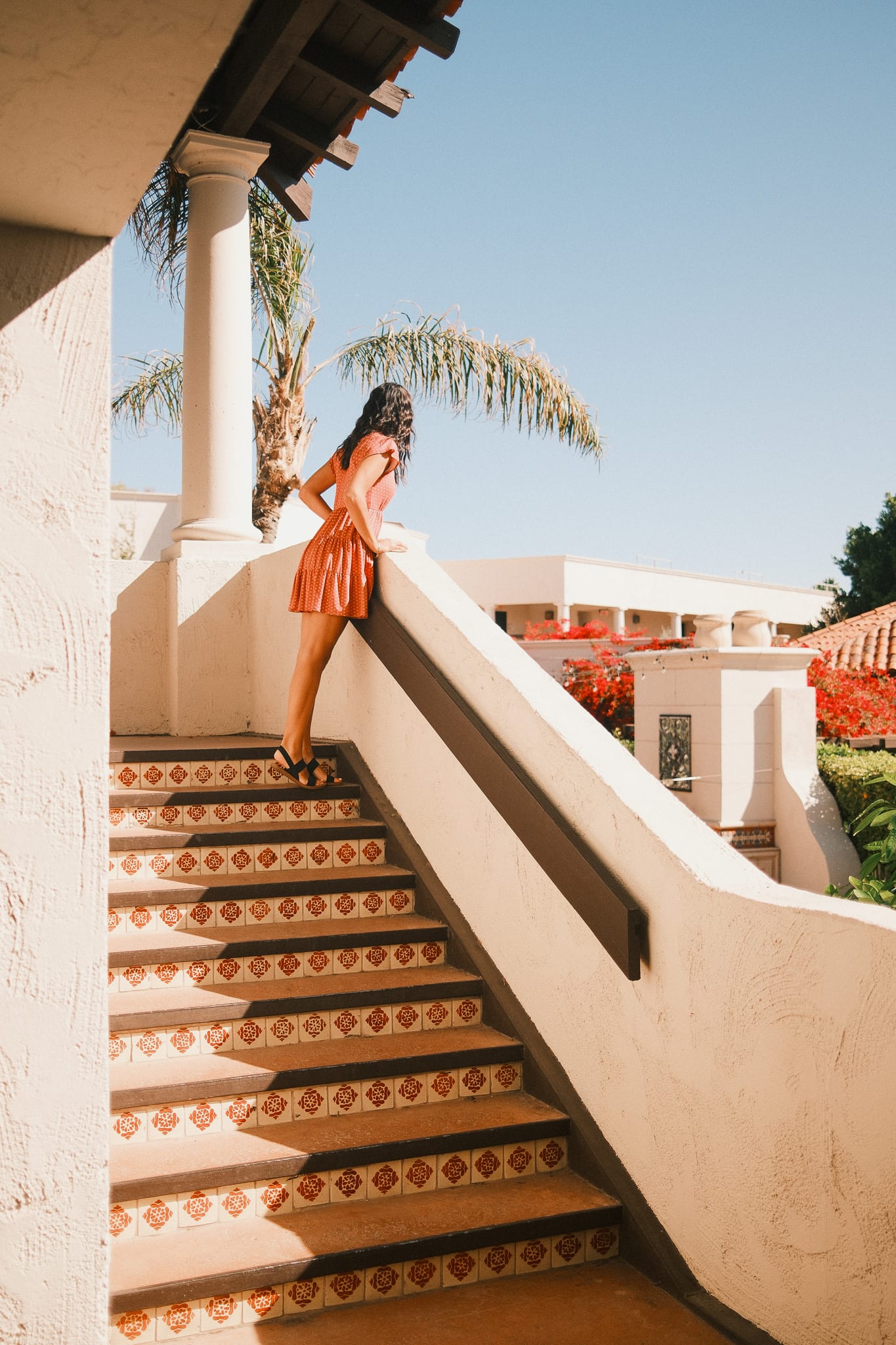 Guest walking a sunlit staircase at Scottsdale Resort and Spa